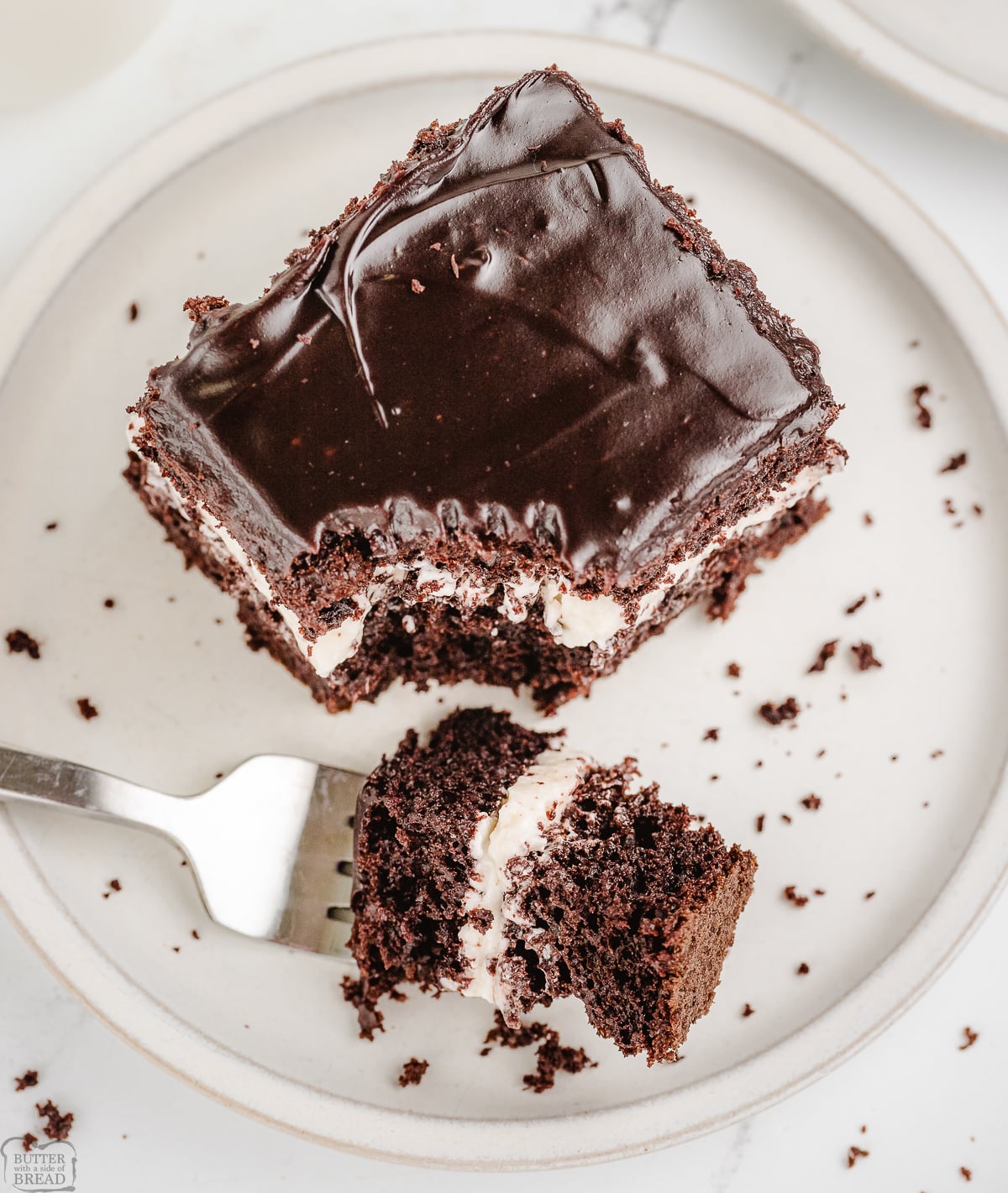 taking a bite of a chocolate cream cake