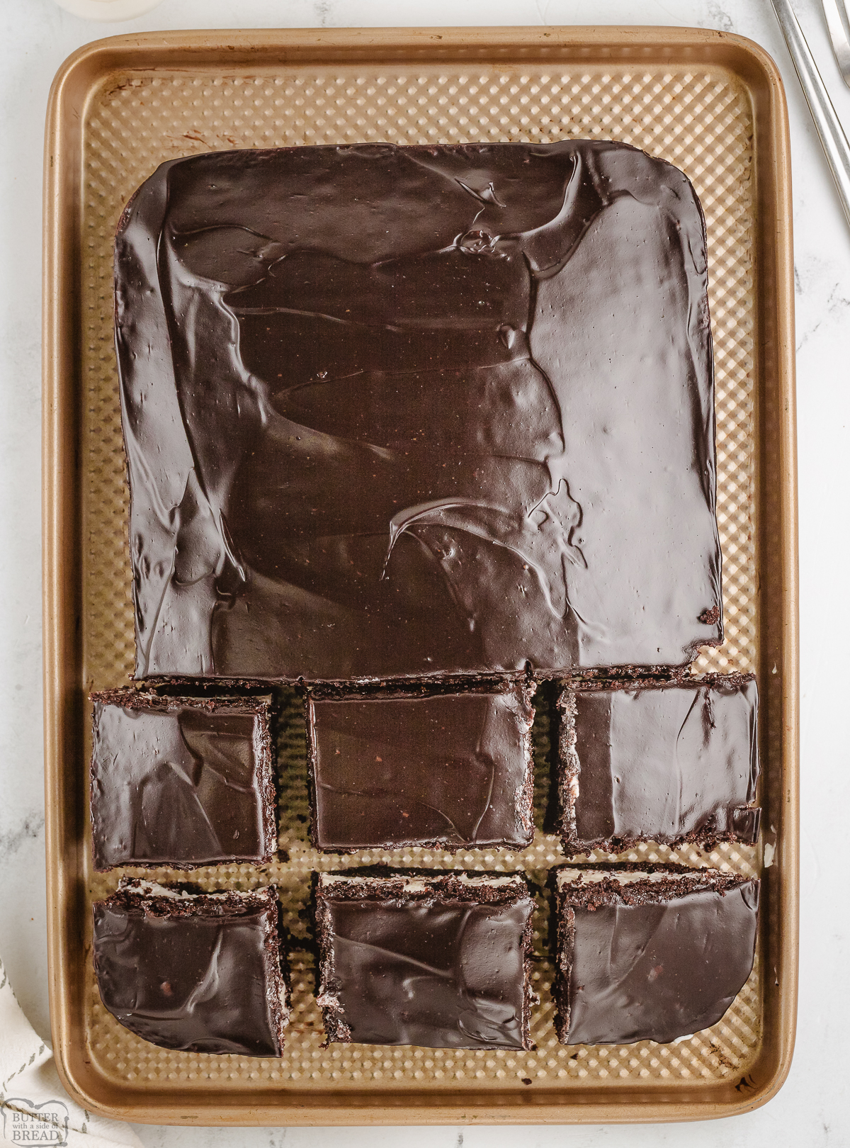 chocolate cream cake sliced into squares