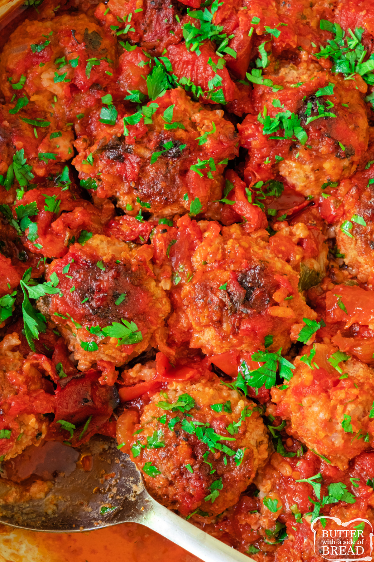 Casserole dish filled with porcupine meatballs simmered in rich tomato sauce.