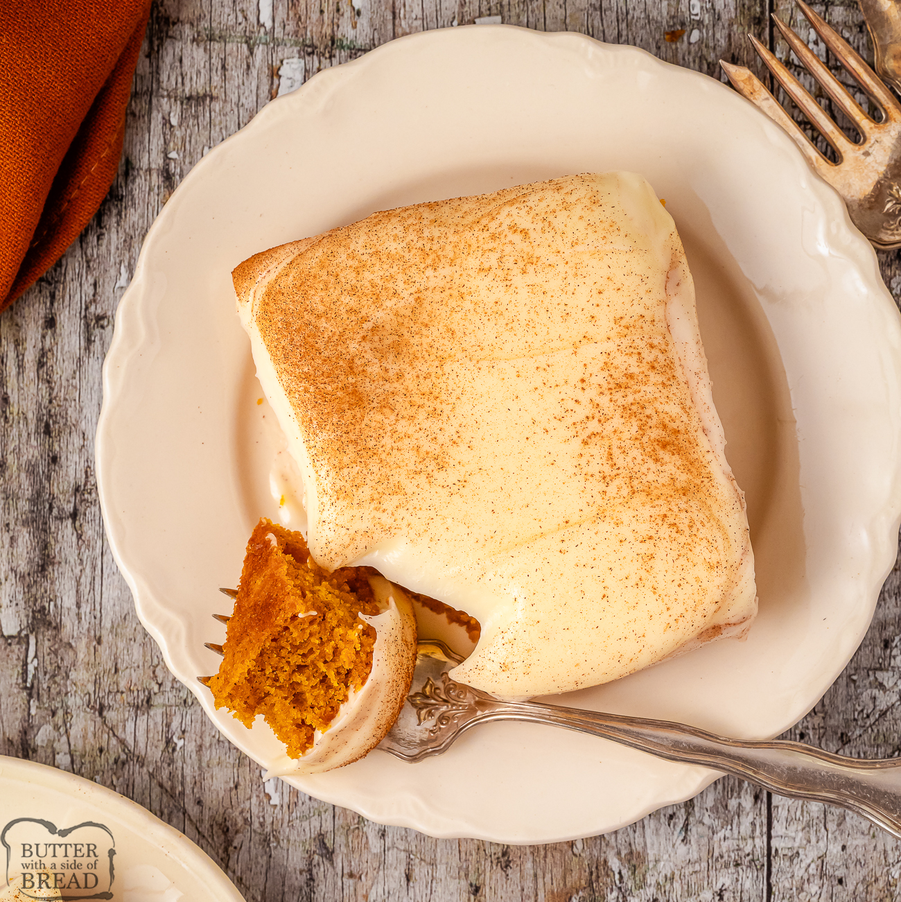 piece of pumpkin sheet cake topped with cream cheese icing