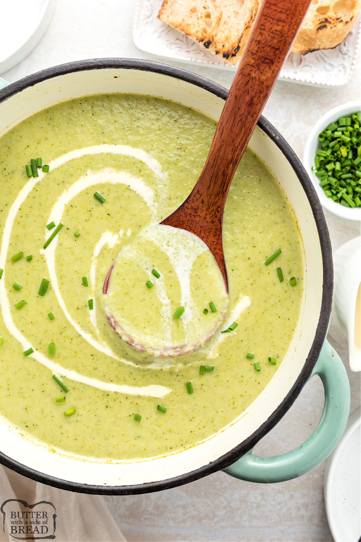 Pot of homemade cream of broccoli soup with a ladle ready to serve.