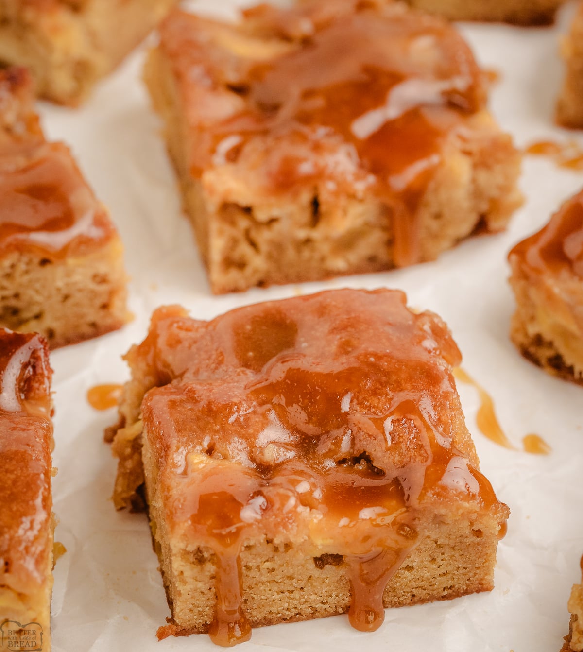 maple apple blondies topped with a brown sugar maple glaze