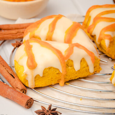iced pumpkin scones on a cooling rack
