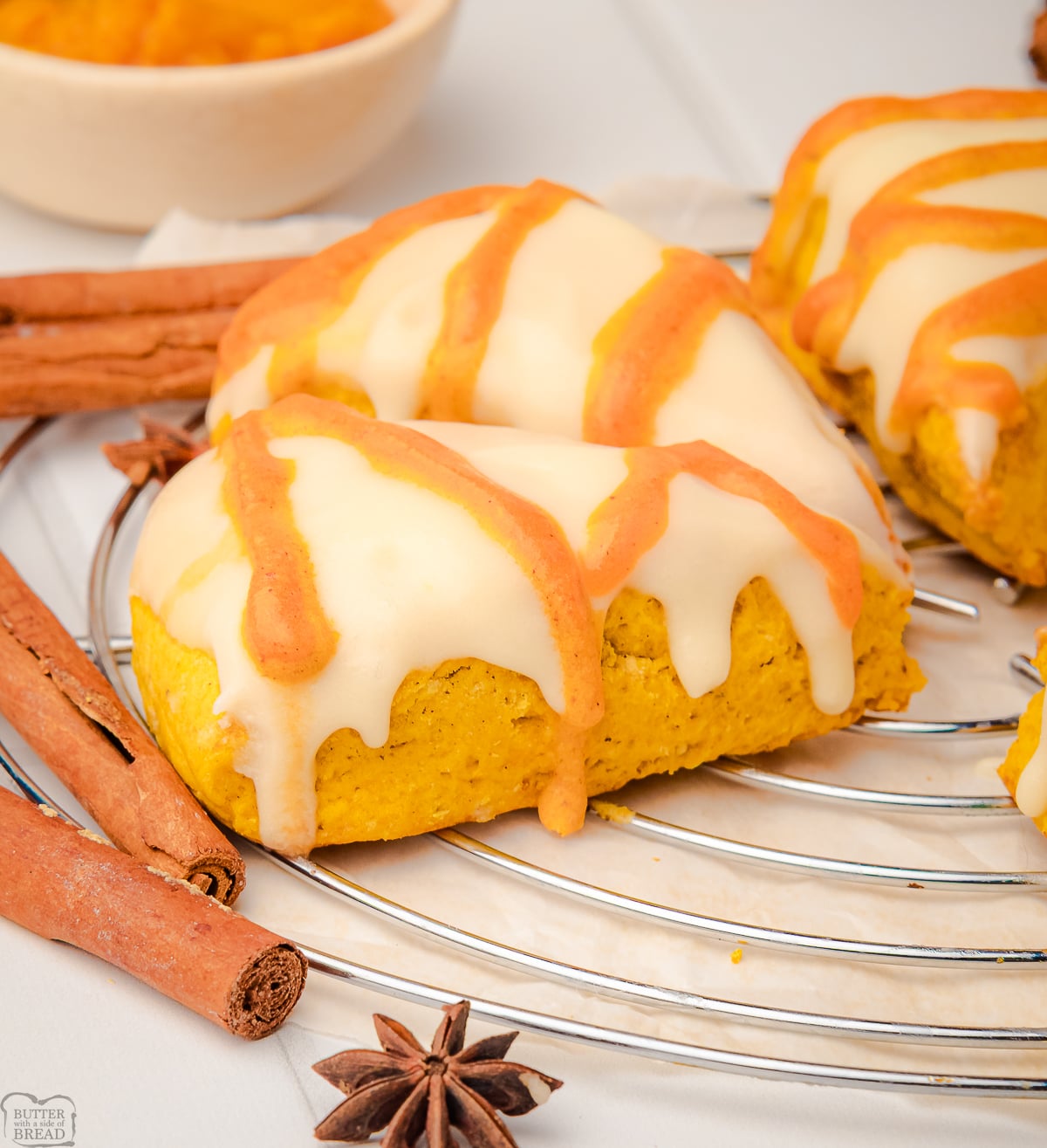 iced pumpkin scones on a cooling rack
