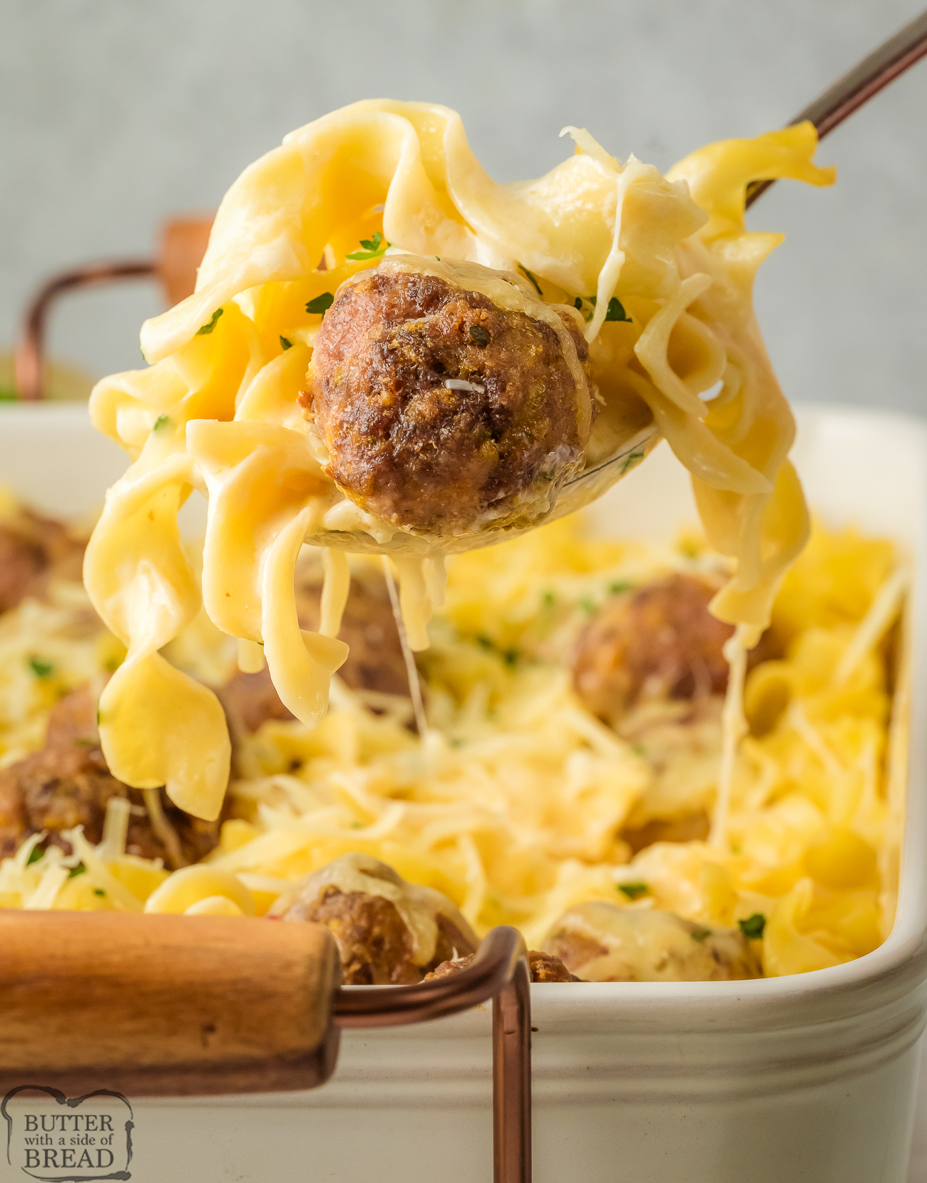 scooping up a serving of Swedish meatball noodle bake