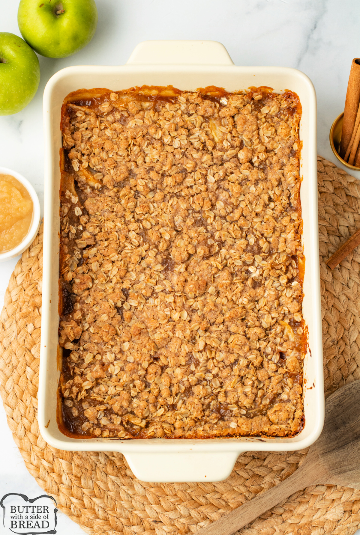 Baked applesauce crisp with golden oat topping in a 9x13 pan.
