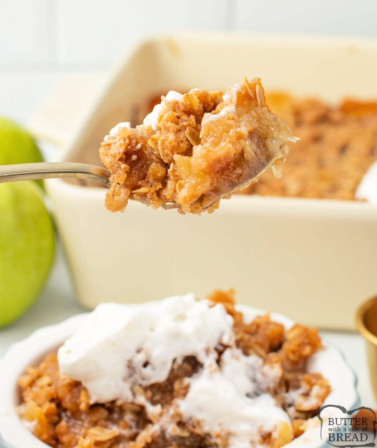 Spoonful of warm applesauce crisp with soft apples and crunchy cinnamon oats.
