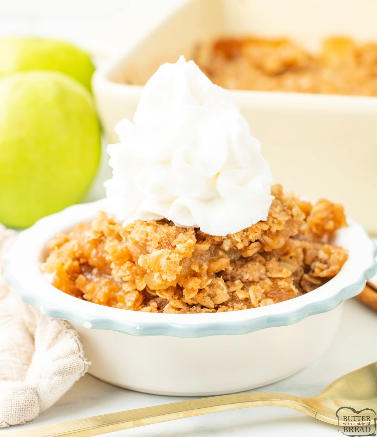 Close-up of applesauce crisp showing tender baked apples and golden oat topping.