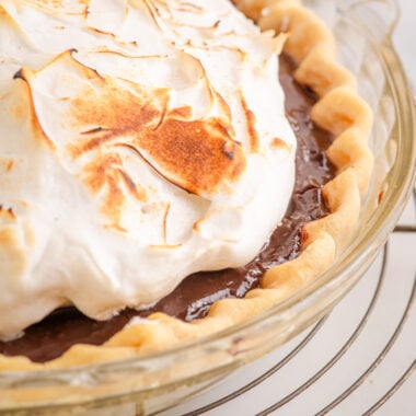 chocolate meringue pie in a glass pie plate