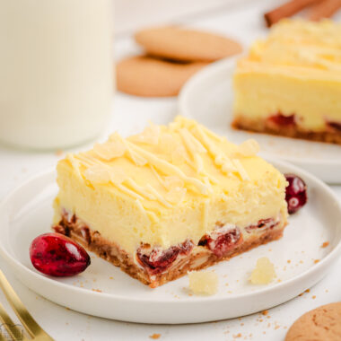 cranberry cheesecake eggnog bar on a white plate