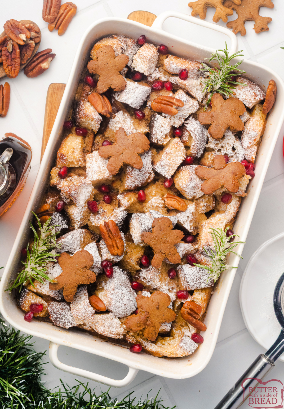 Holiday Gingerbread French Toast Casserole topped with pecans and ginger cookie crumbs.