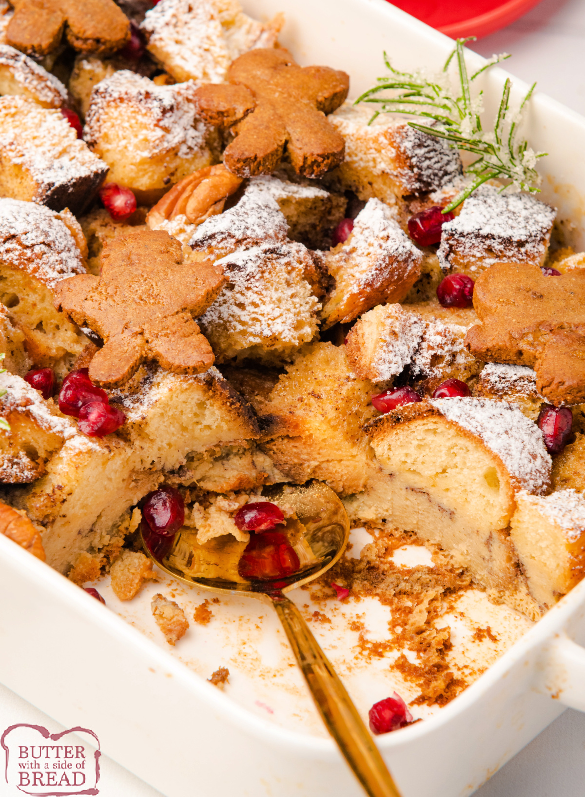 Gingerbread French Toast Casserole baked in a dish with a golden, spiced top and powdered sugar.