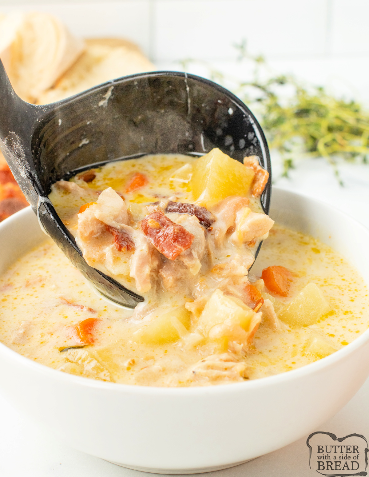 Close-up of creamy chicken potato soup with tender potatoes and chicken.