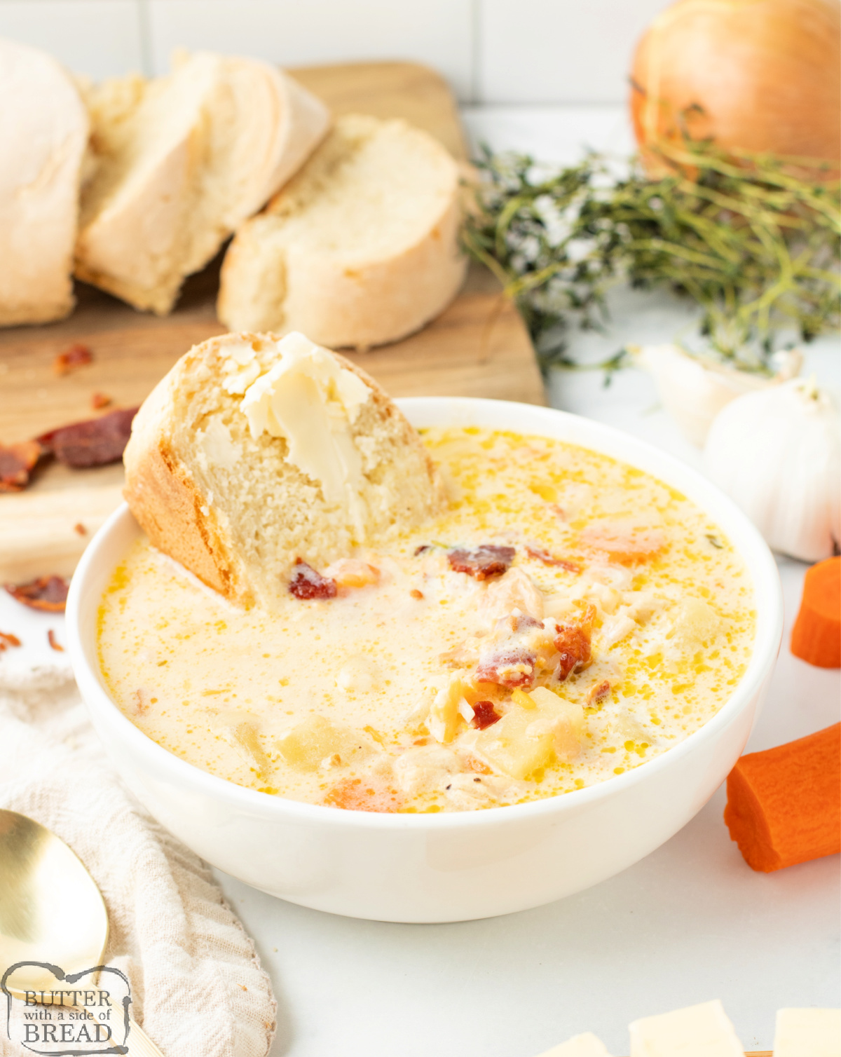 Bowl of chicken potato soup topped with bacon and shredded cheese.