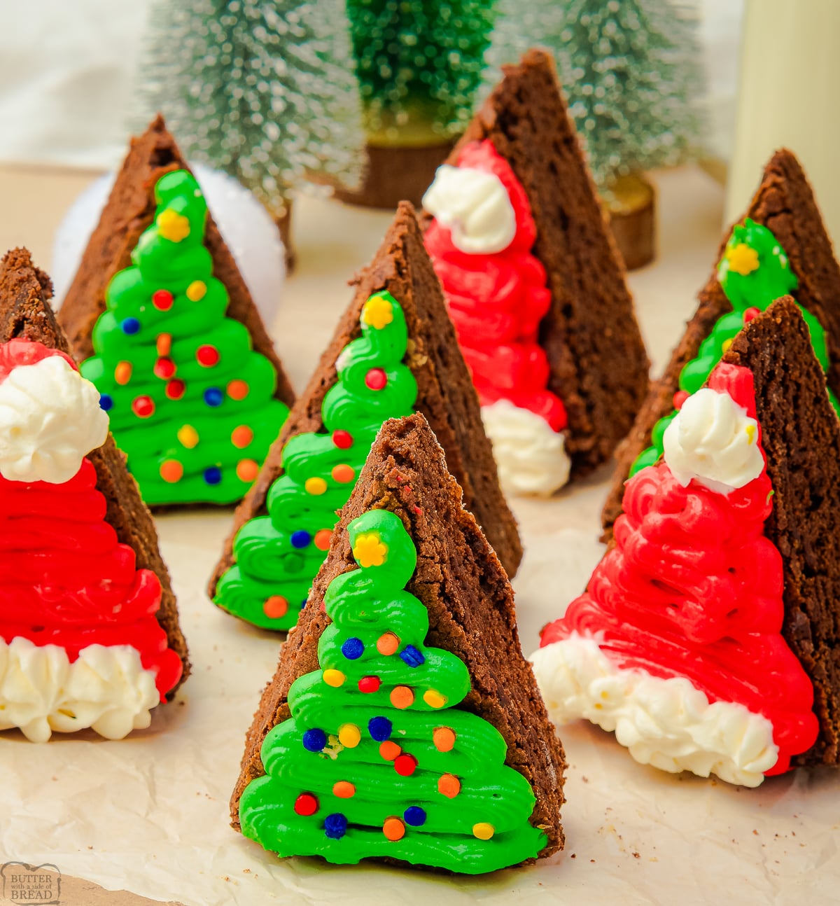Brownie wedges frosted to look like Christmas trees and Santa hats