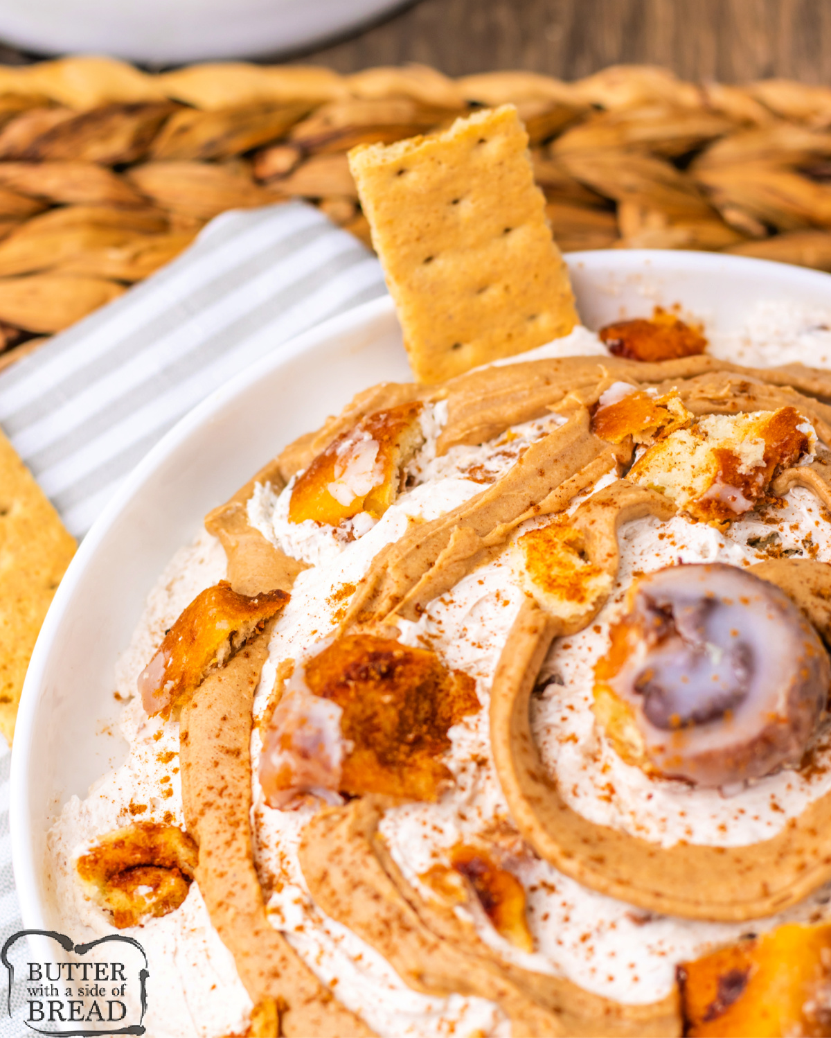 Rich cinnamon dip swirled with icing and garnished with chopped cinnamon rolls.