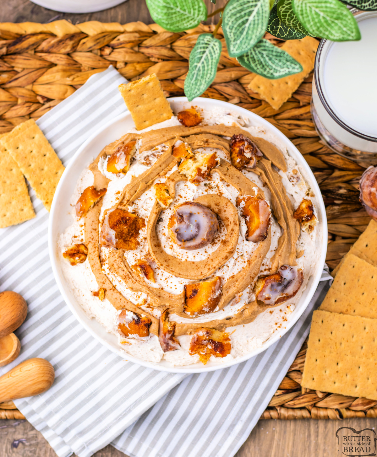 Rich cinnamon dip swirled with icing and garnished with chopped cinnamon rolls.