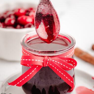 Cranberry Syrup in a small jar with a red bow