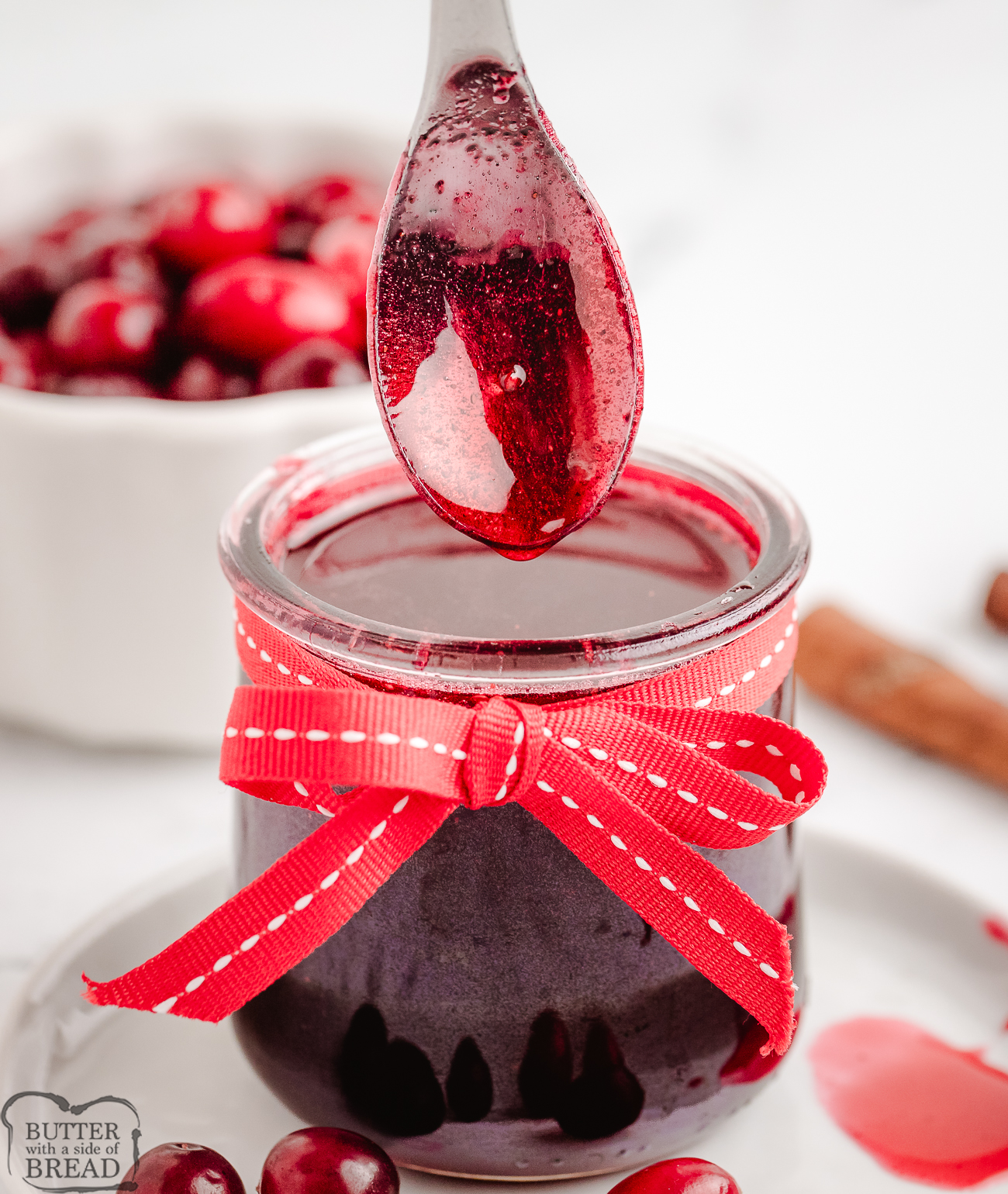 Cranberry Syrup in a small jar with a red bow