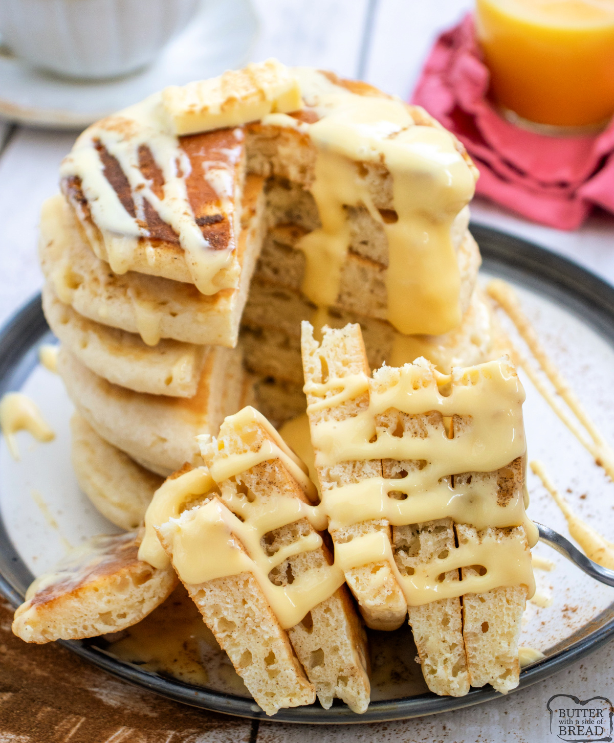 Holiday eggnog pancakes smothered in eggnog glaze and cinnamon.