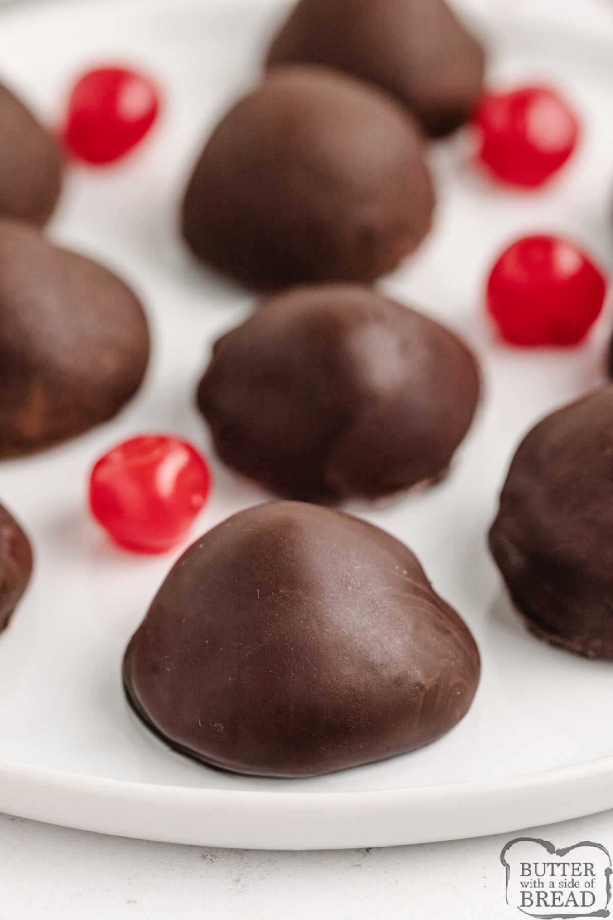 Close-up of homemade chocolate-covered cherries with a glossy chocolate shell.