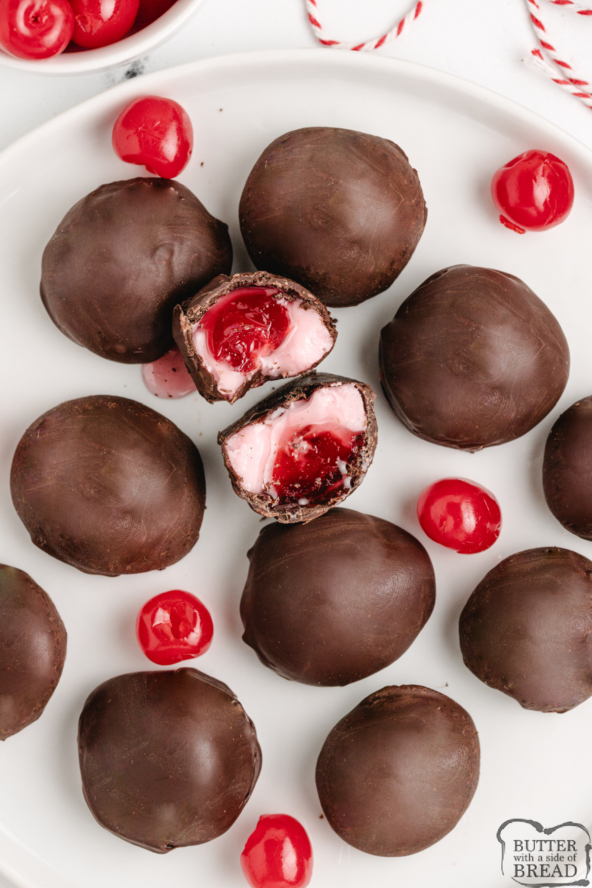 Tray of freshly dipped chocolate-covered cherries with smooth, shiny coating.