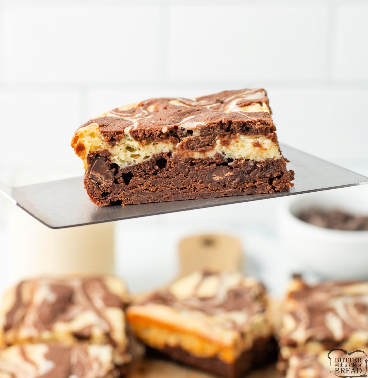 Close-up of cheesecake brownies showing chocolate and cheesecake layers.