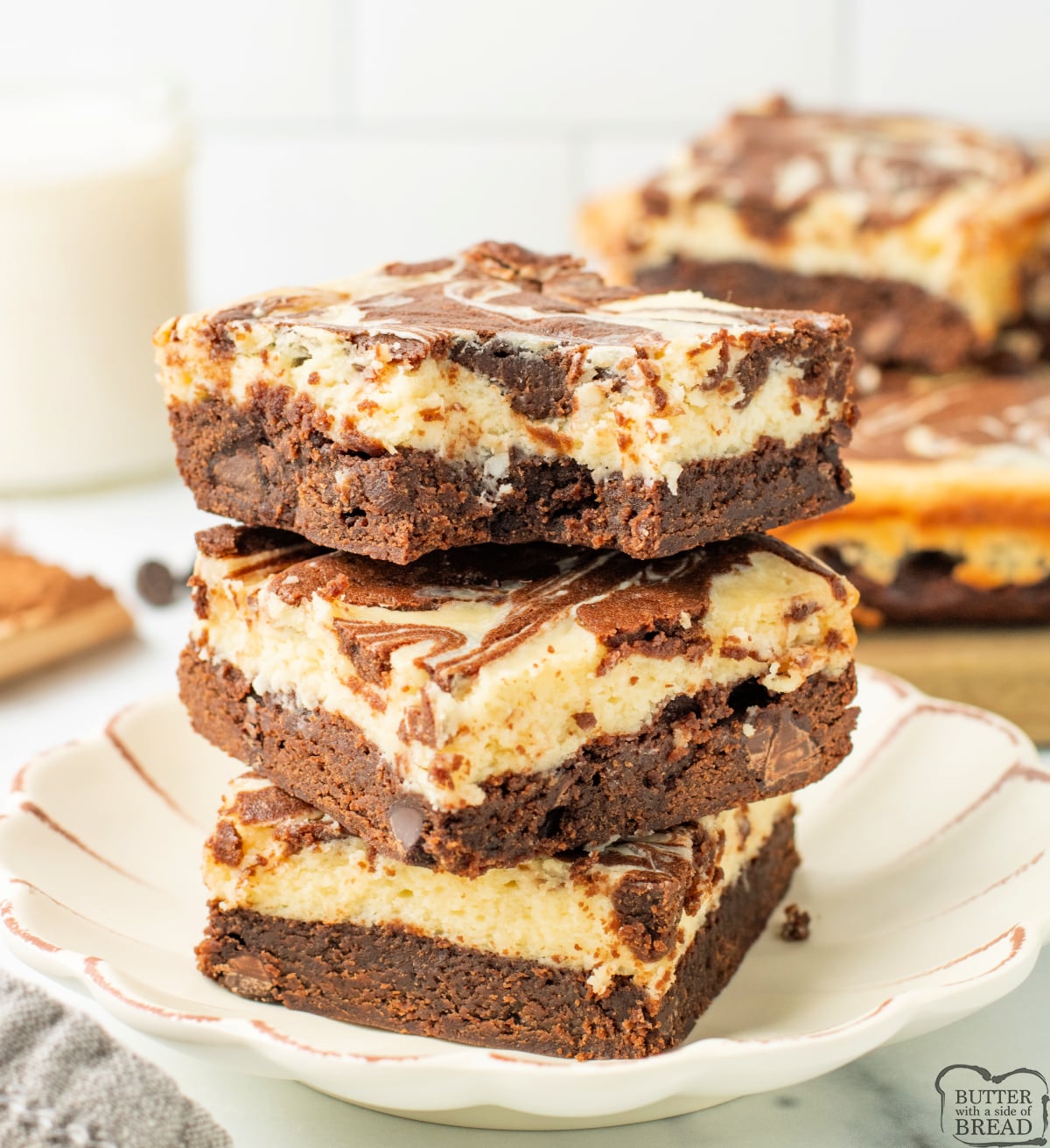 Close-up of cheesecake brownies showing chocolate and cheesecake layers.