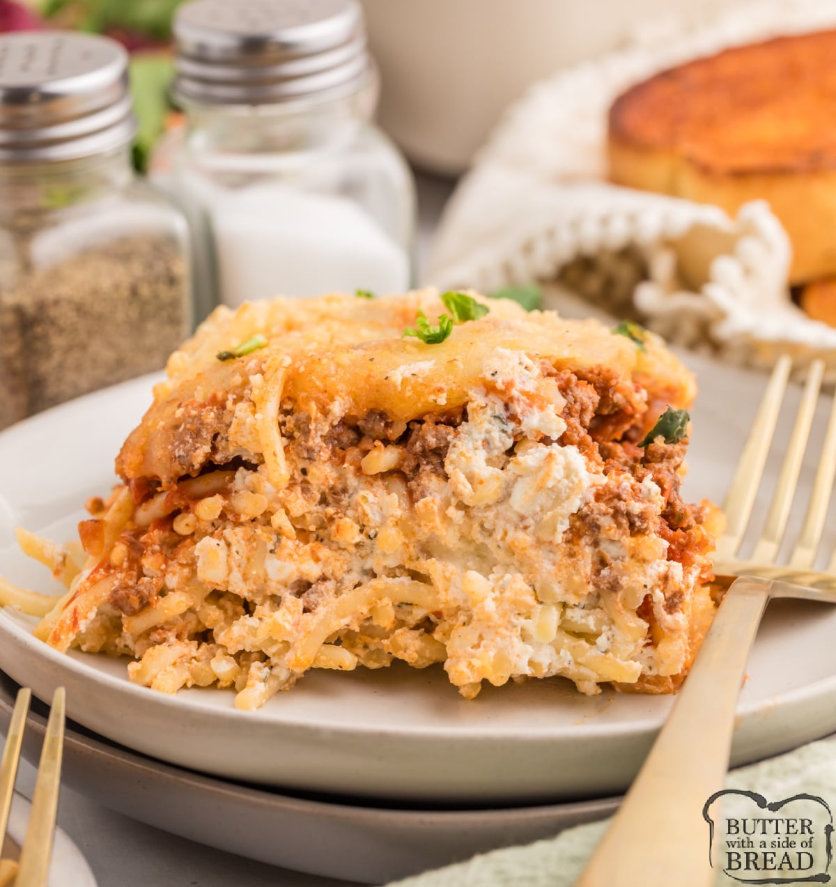 Million dollar spaghetti bake with creamy layers and melted cheese.