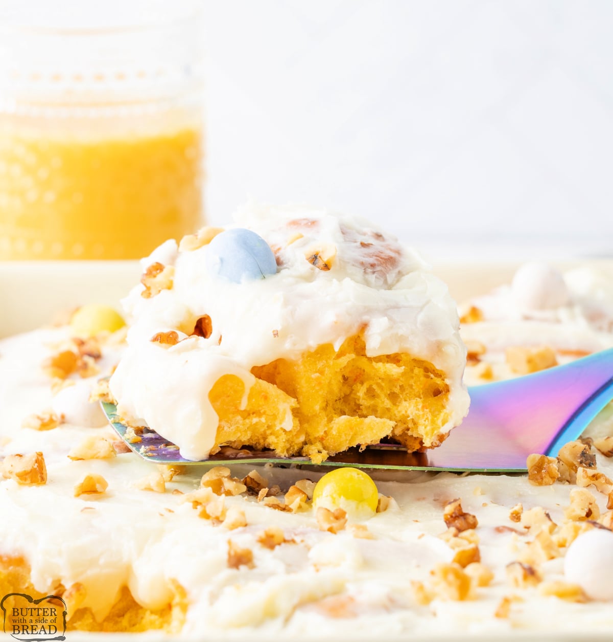 Homemade carrot cake cinnamon rolls with shredded carrots and creamy frosting.