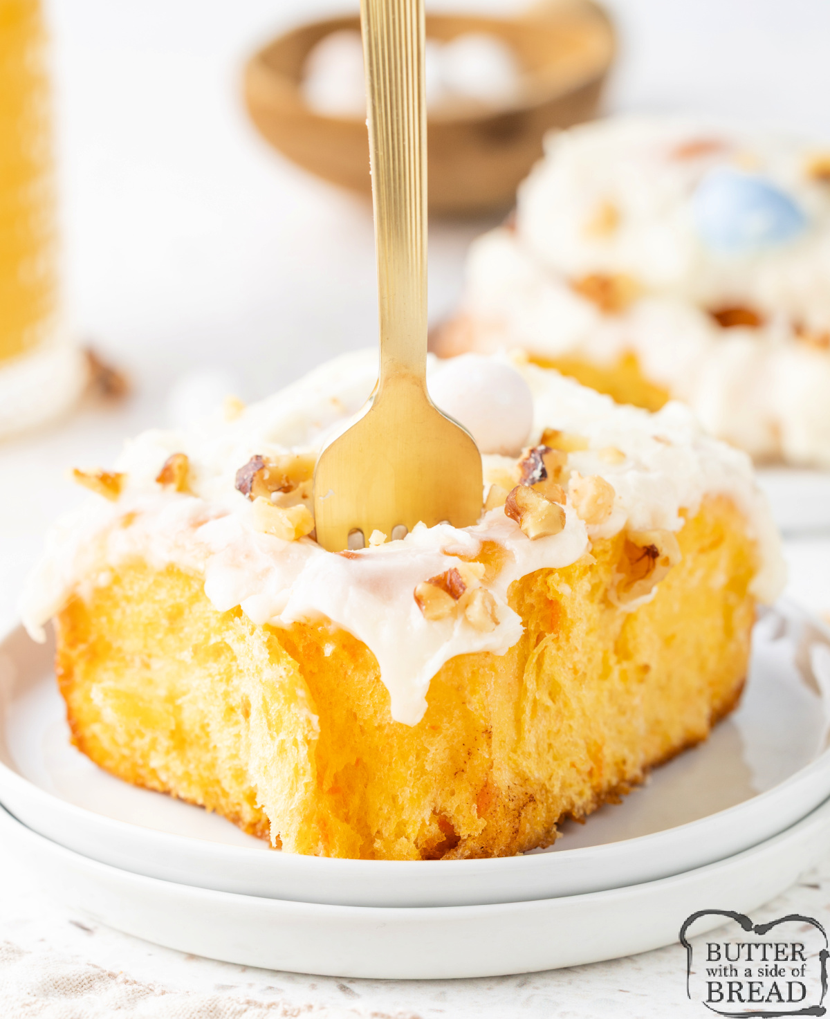 Close-up of fluffy carrot cake cinnamon rolls with cream cheese frosting.