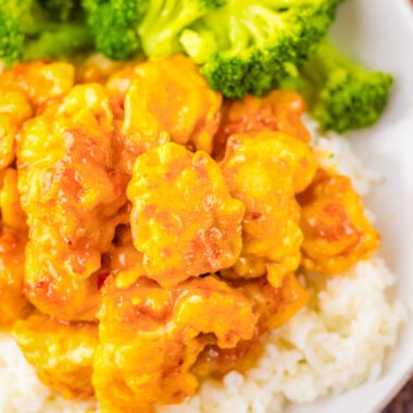 Panda Express Copycat Orange Chicken on a white plate with rice and broccoli