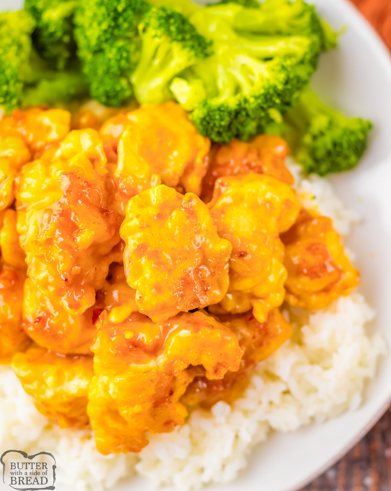 Panda Express Copycat Orange Chicken on a white plate with rice and broccoli