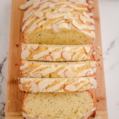 loaf of sliced poppy seed bread on a cutting board