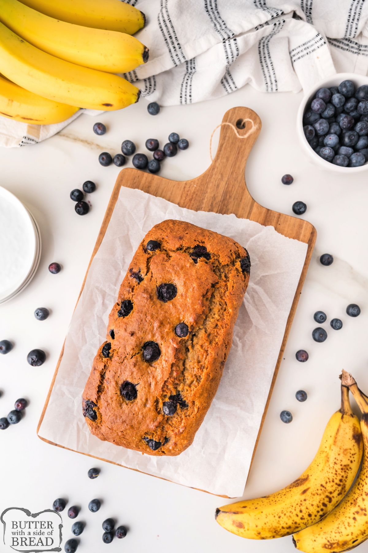 A homemade blueberry banana bread loaf with a golden brown crust.