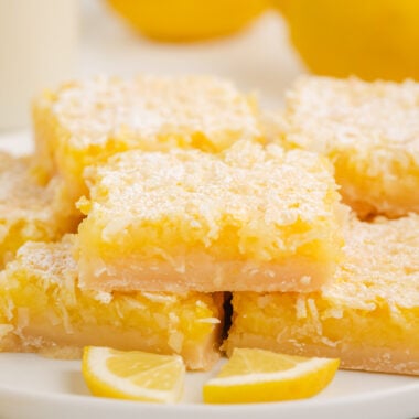 coconut lemon bars on a white plate