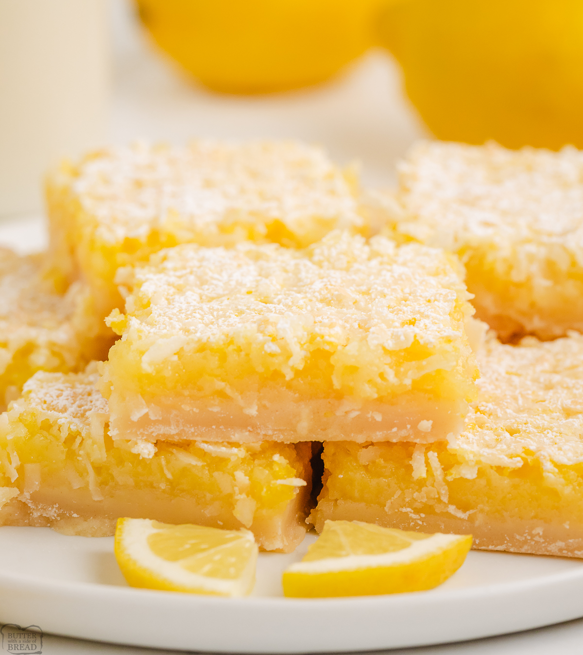 coconut lemon bars on a white plate