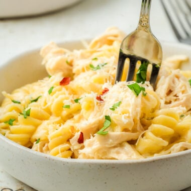 crock pot Italian chicken dinner in a bowl with a fork