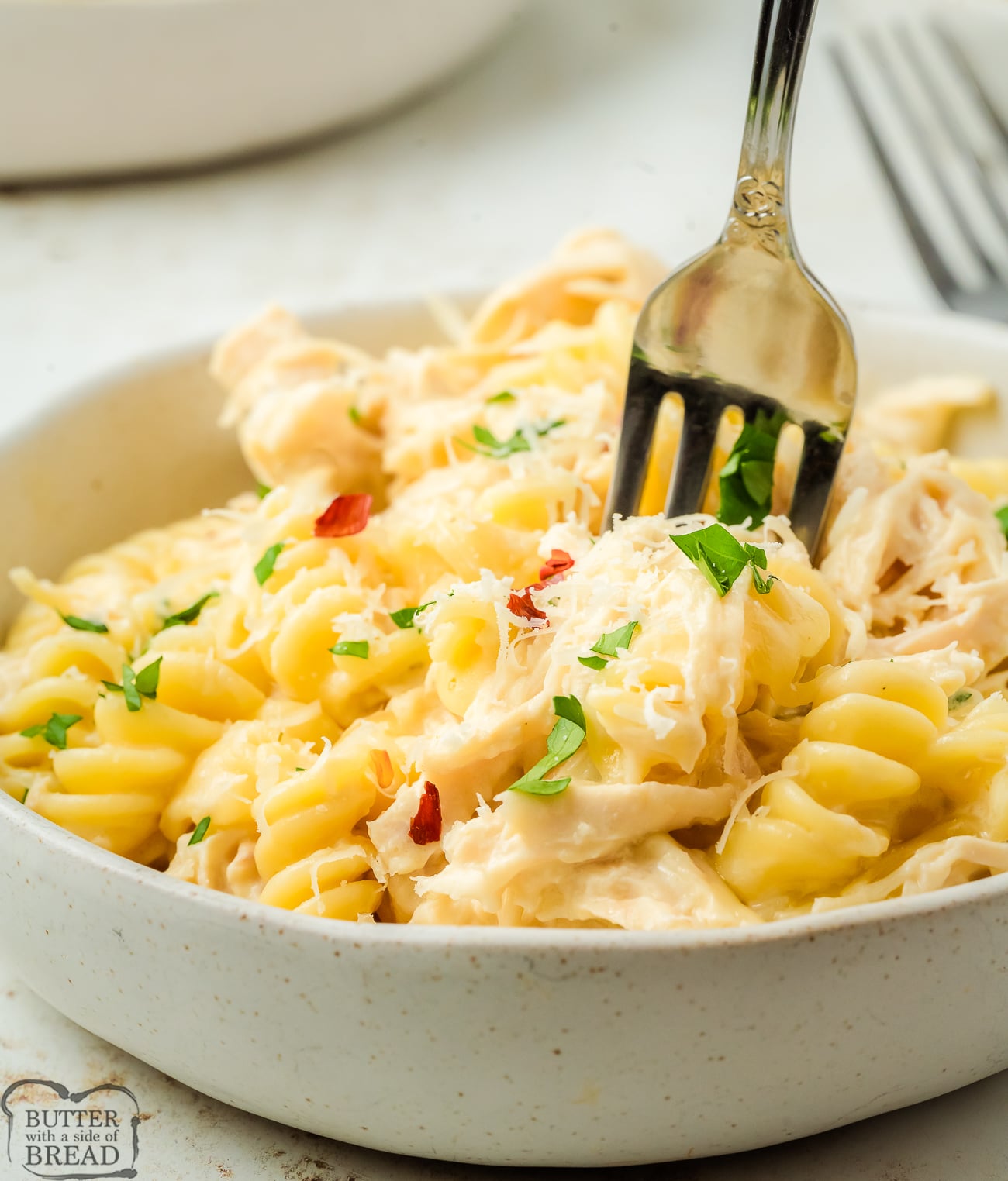 crock pot Italian chicken dinner in a bowl with a fork
