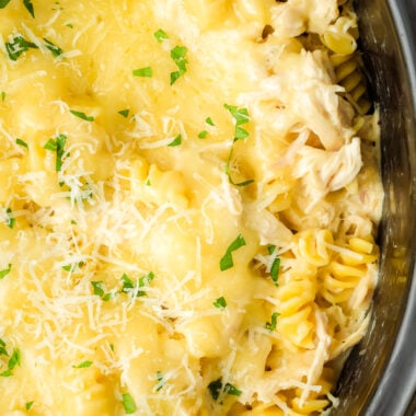 crockpot Italian chicken and pasta dinner topped with cheese