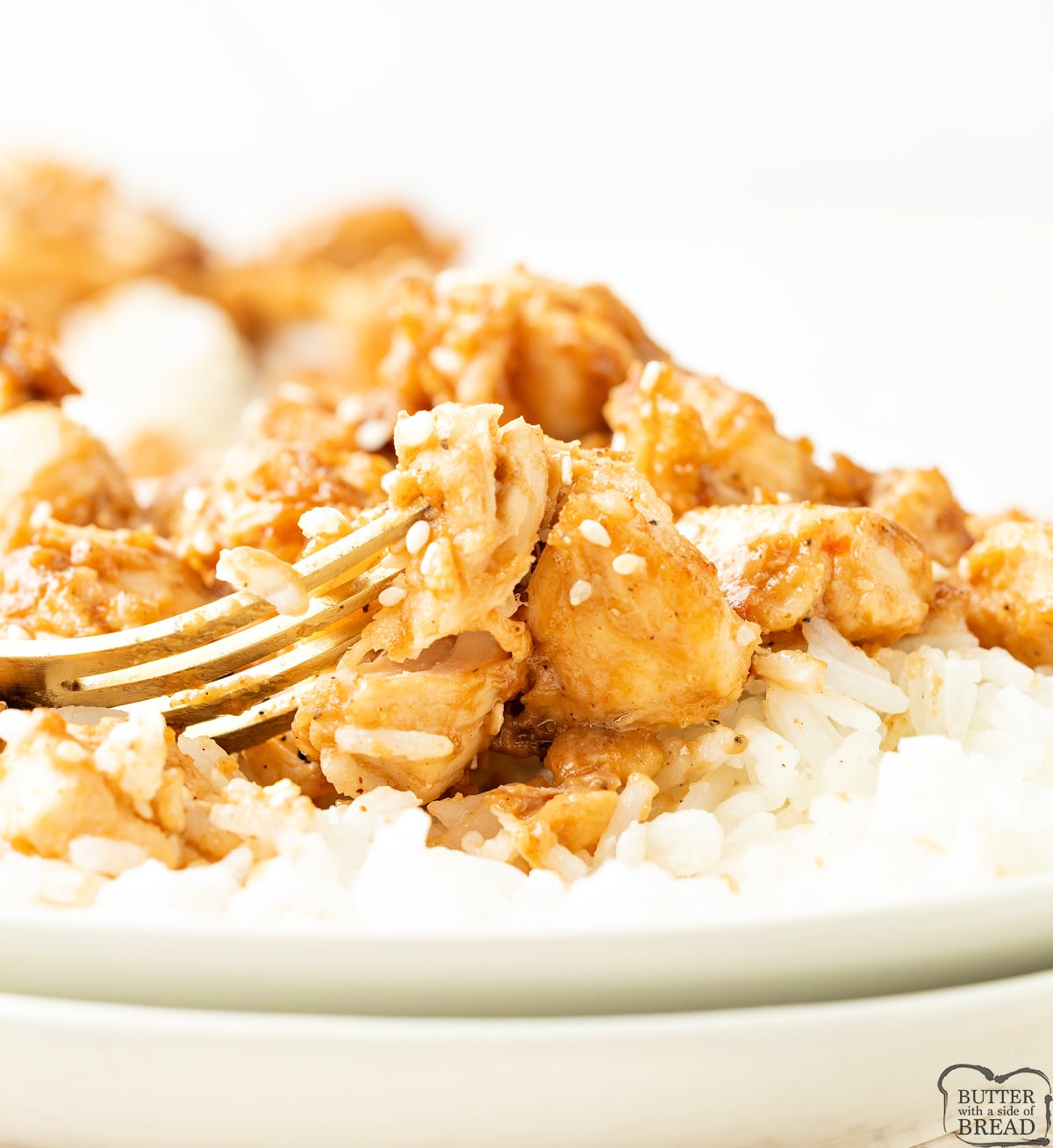 Easy peanut butter chicken recipe served over rice with sesame seeds, made in one skillet in under 30 minutes.