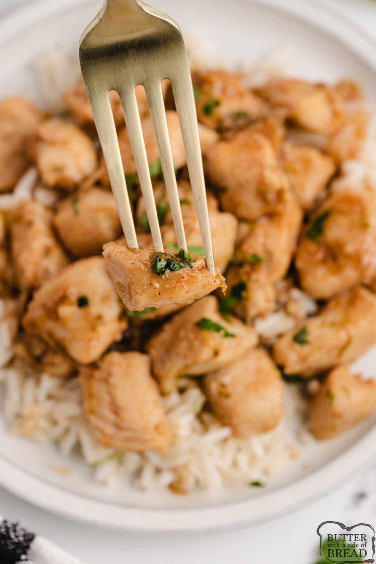 Close up of honey lime chicken pieces coated in a glossy sweet and tangy honey lime sauce.