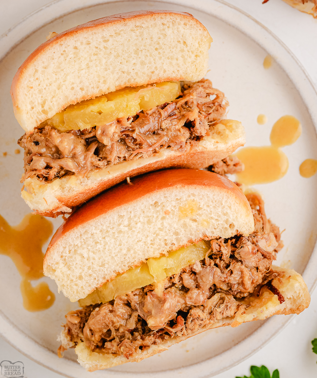 two sandwiches with teriyaki pulled pork cut in half