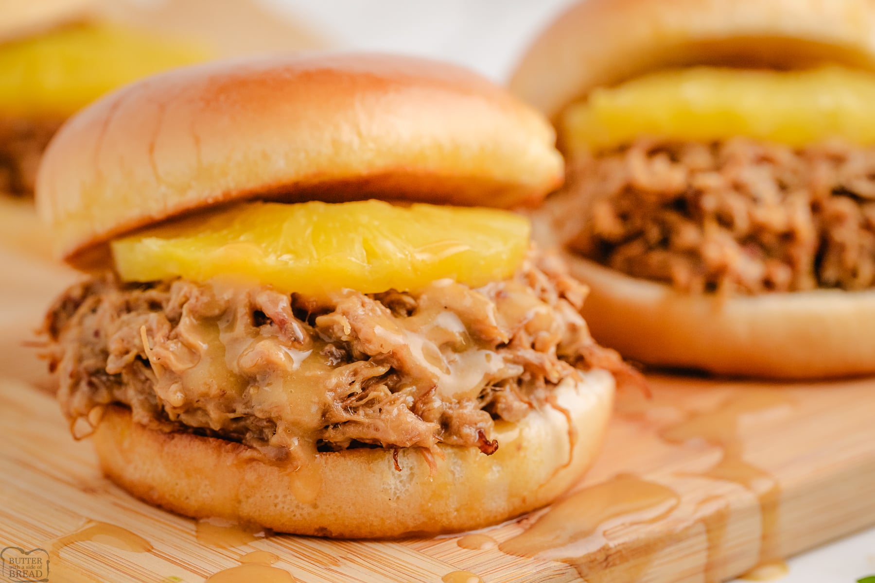 teriyaki pulled pork on a bun with a slice of pineapple