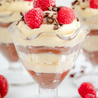 homemade mousse with layers and white chocolate and semi sweet chocolate topped with berries