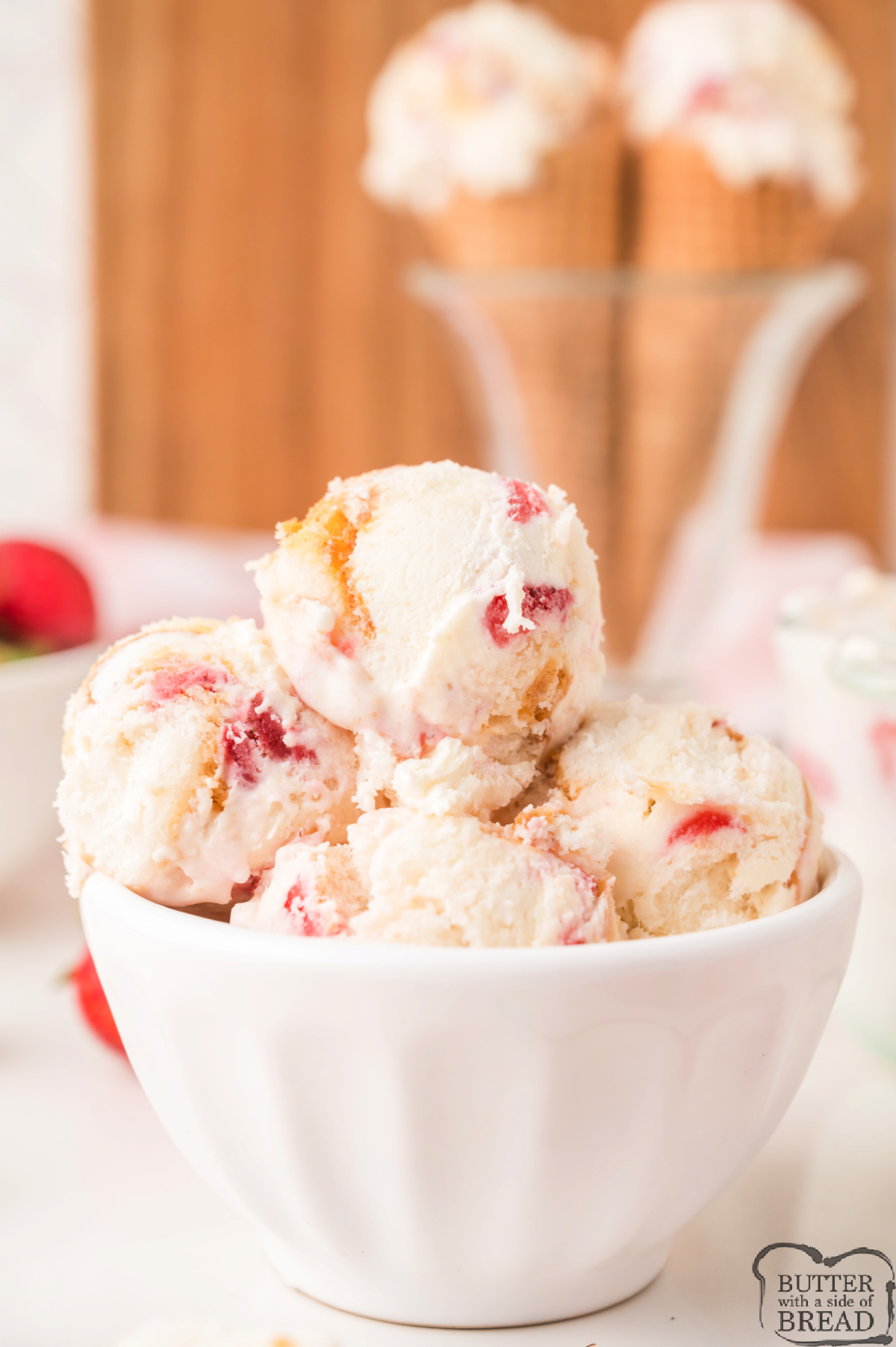 Homemade strawberry ice cream with cake chunks and fresh strawberry swirls.