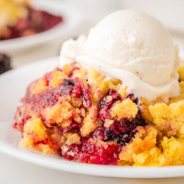 blackberry dump cake topped with vanilla ice cream
