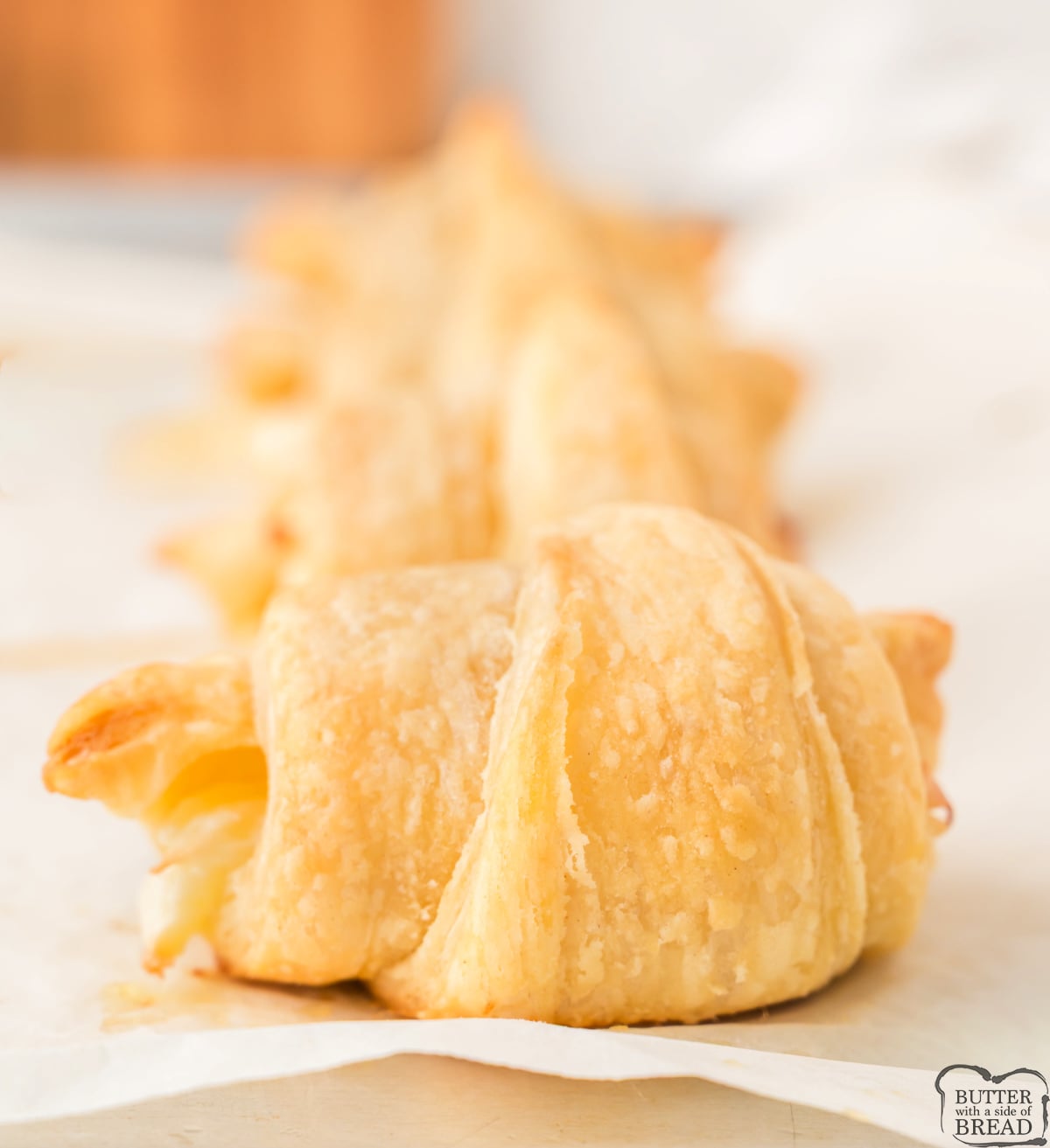 Close up of a cream cheese croissant showing flaky layers and filling
