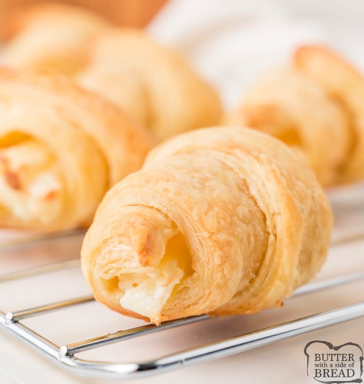 Close up of a cream cheese croissant showing flaky layers and filling