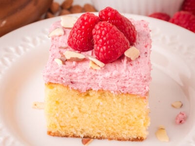 slice of Raspberry Almond sheet cake on a white plate